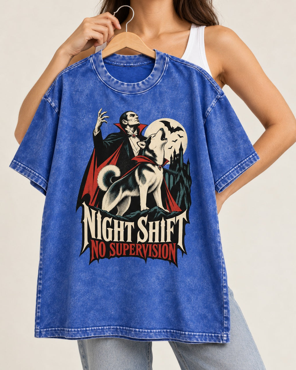 Husky Night Shift No Supervision Vampire Graphic Washed Tee in Royal Blue, held up on a hanger