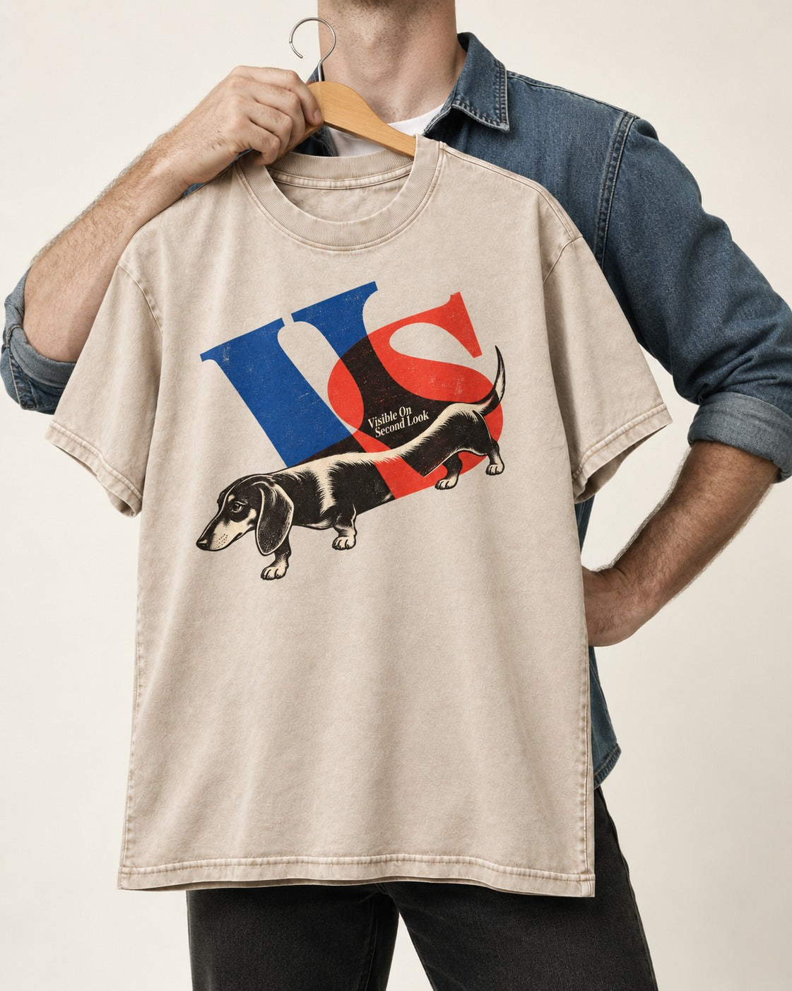Dachshund VS Visible On Second Look Graphic Washed Tee in Apricot, held up on a hanger
