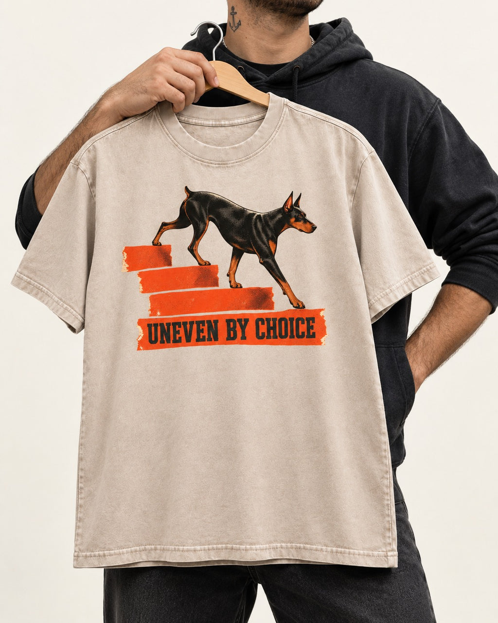 Doberman Uneven by Choice Stair Graphic Washed Tee in Apricot, held up on a hanger