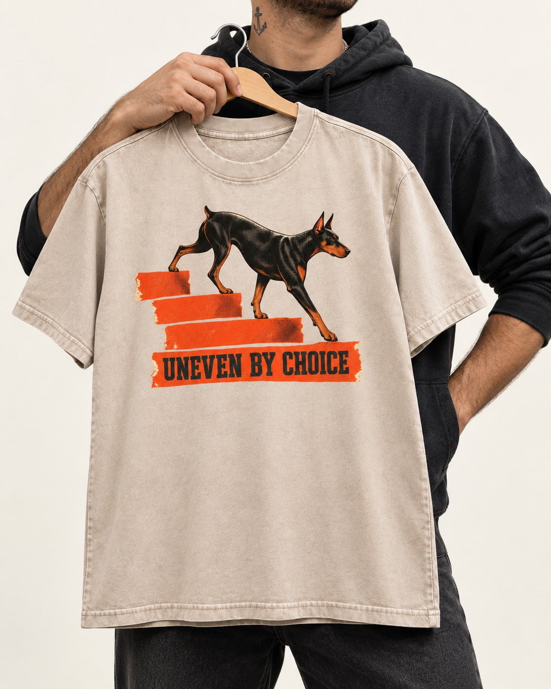 Doberman Uneven by Choice Stair Graphic Washed Tee in Apricot, held up on a hanger