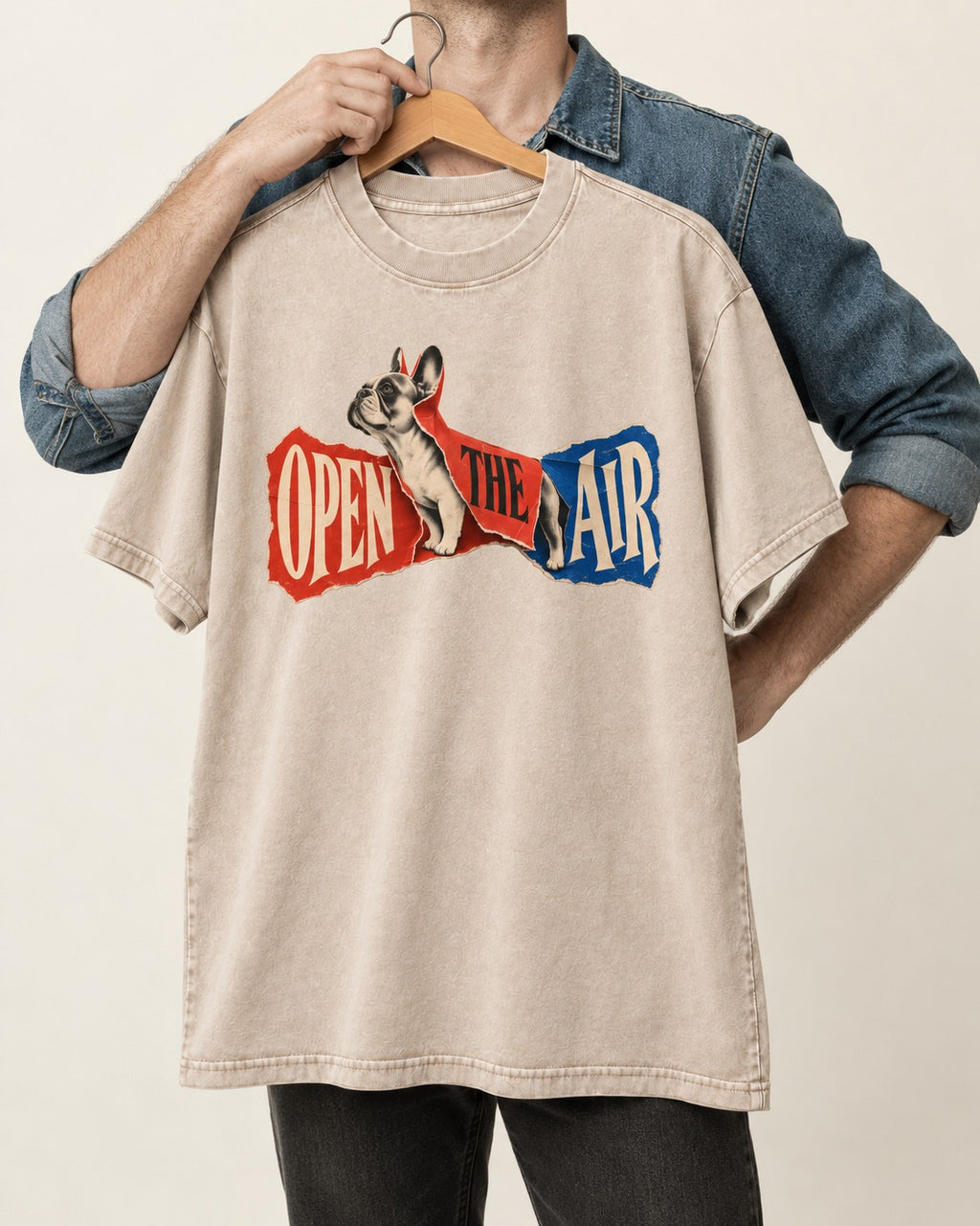 Frenchie Open the Air Torn Poster Graphic Washed Tee in Apricot, held up on a hanger