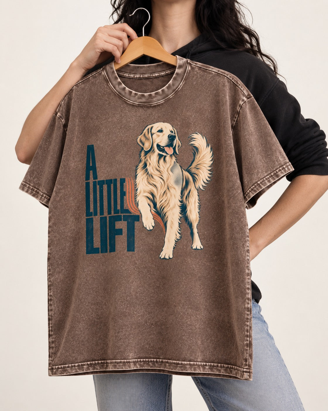 A Little Lift Golden Retriever Washed Tee in Coffee, held up on a hanger