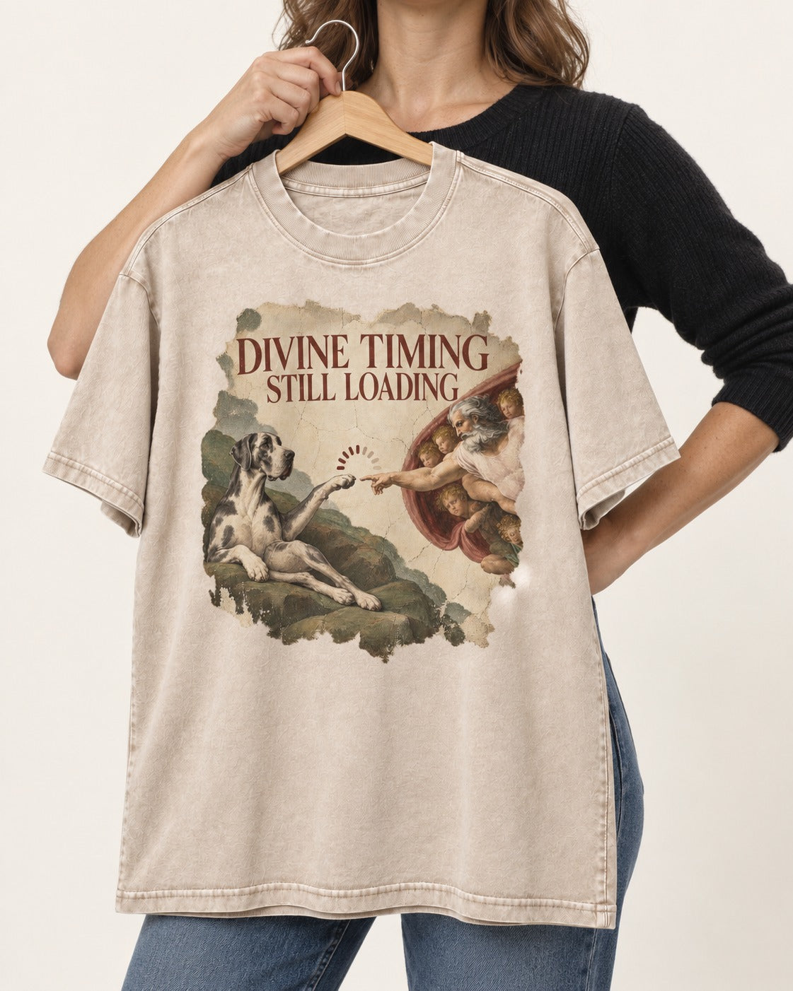 Great Dane Divine Timing Still Loading Washed Tee in Apricot, held up on a hanger