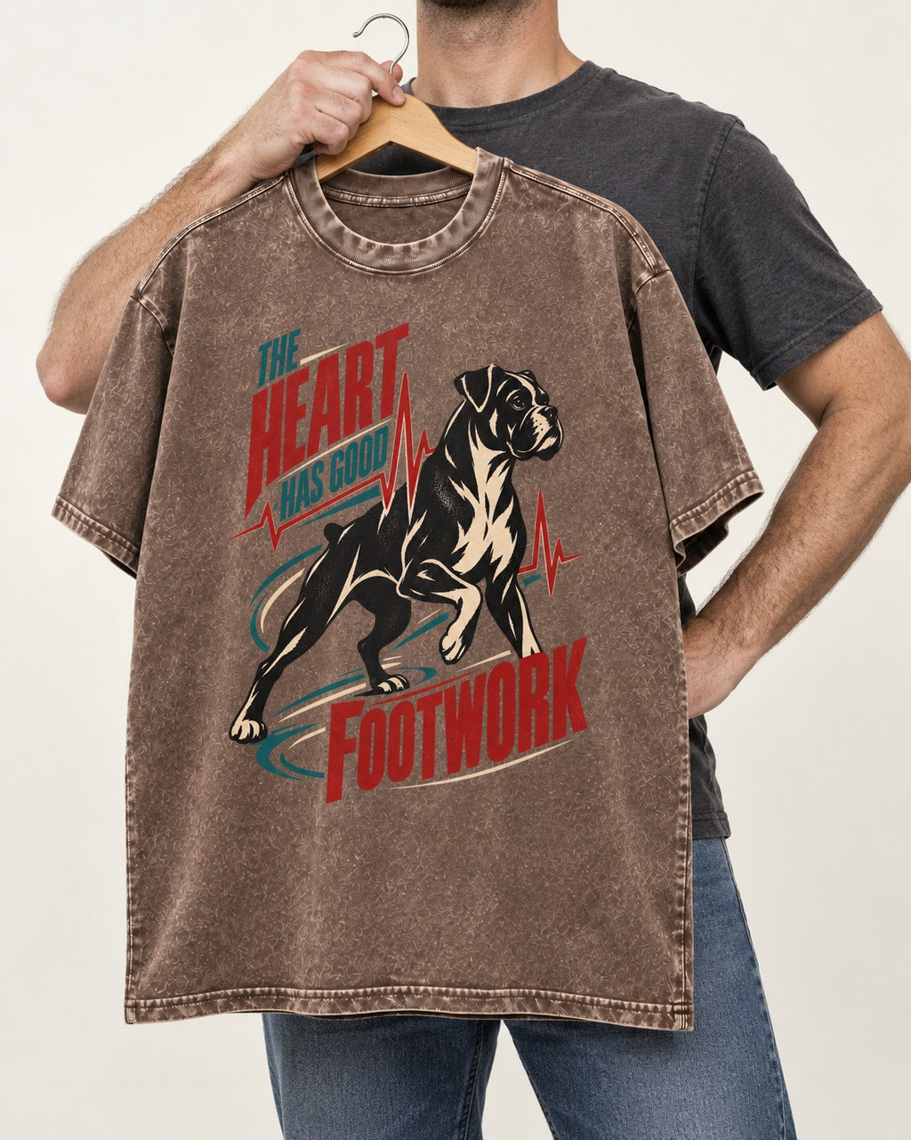 Boxer Heart Has Good Footwork Washed Tee in Coffee, held up on a hanger