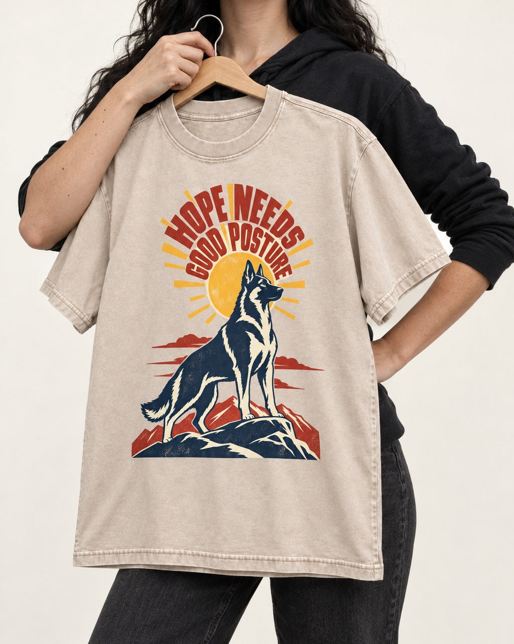 Hope Needs Good Posture German Shepherd Dog Washed Tee in Apricot, held up on a hanger