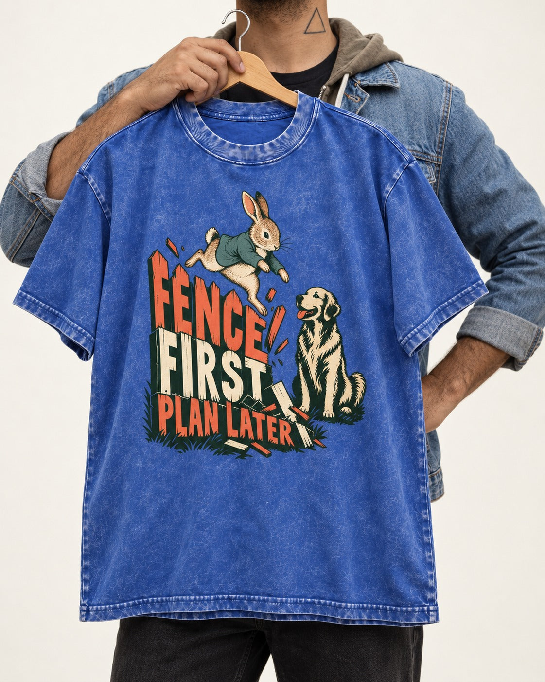 Golden Retriever Fence First Plan Later Rabbit Jump Graphic Washed Tee in Royal Blue, held up on a hanger