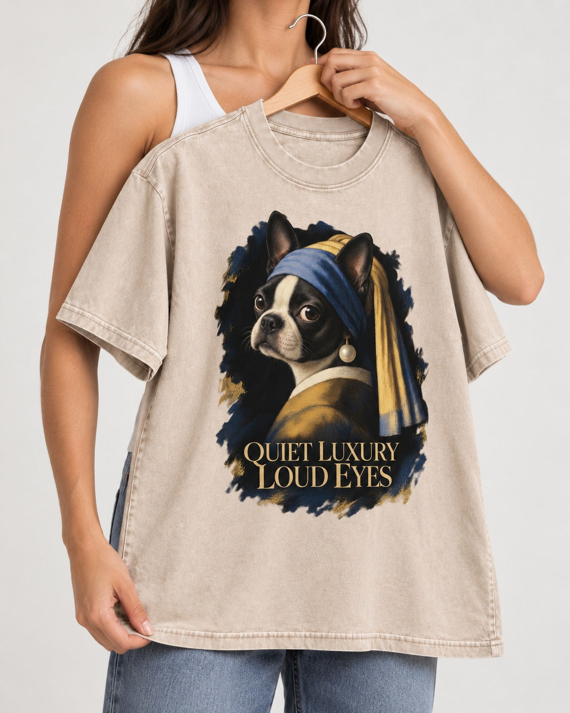 Quiet Luxury Loud Eyes Boston Terrier Pearl Portrait Washed Tee in Apricot, held up on a hanger
