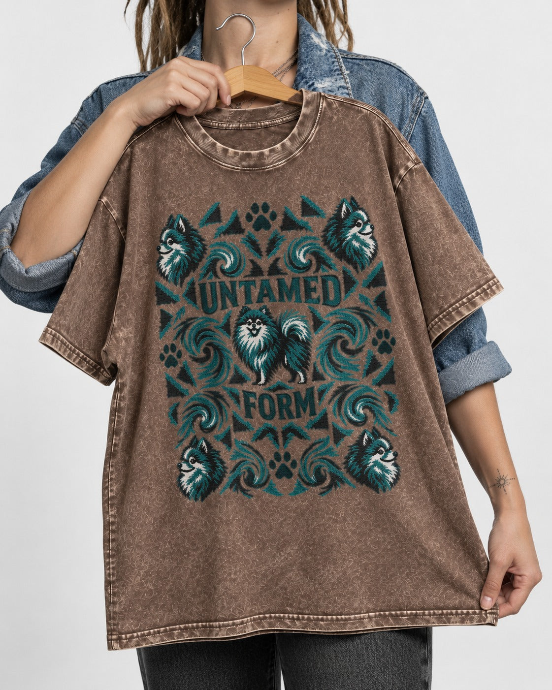 Pomeranian Untamed Form Washed Tee in Coffee, held up on a hanger