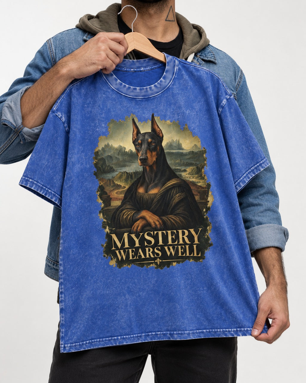 Doberman Mystery Wears Well Renaissance Portrait Graphic Washed Tee in Royal Blue, held up on a hanger