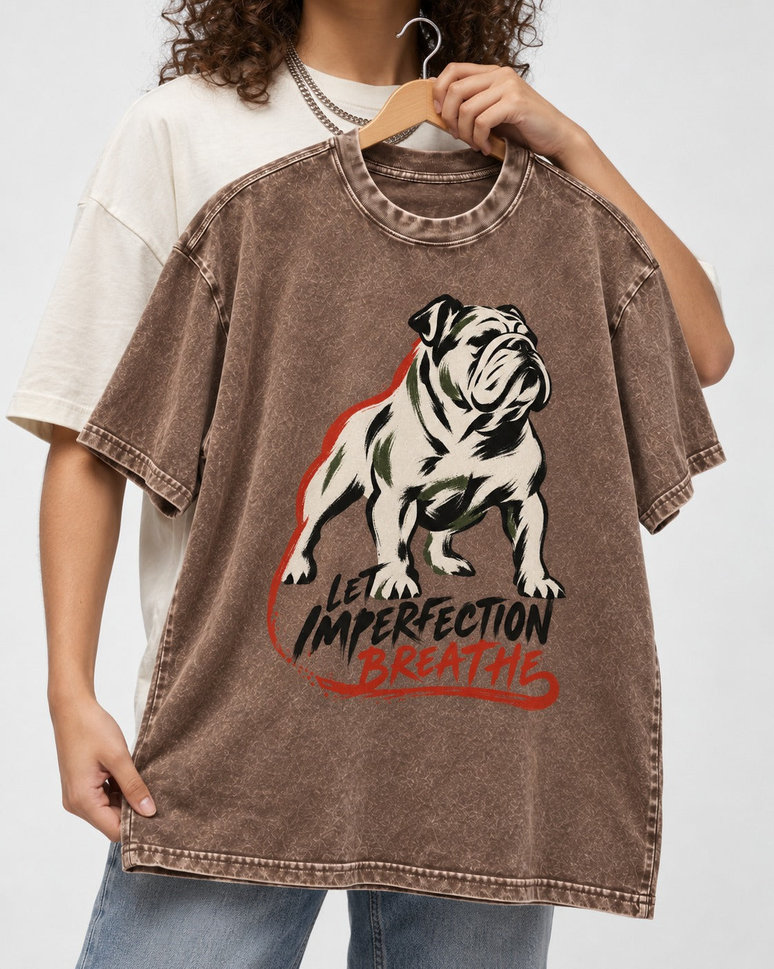 Let Imperfection Breathe English Bulldog Washed Tee in Coffee, held up on a hanger