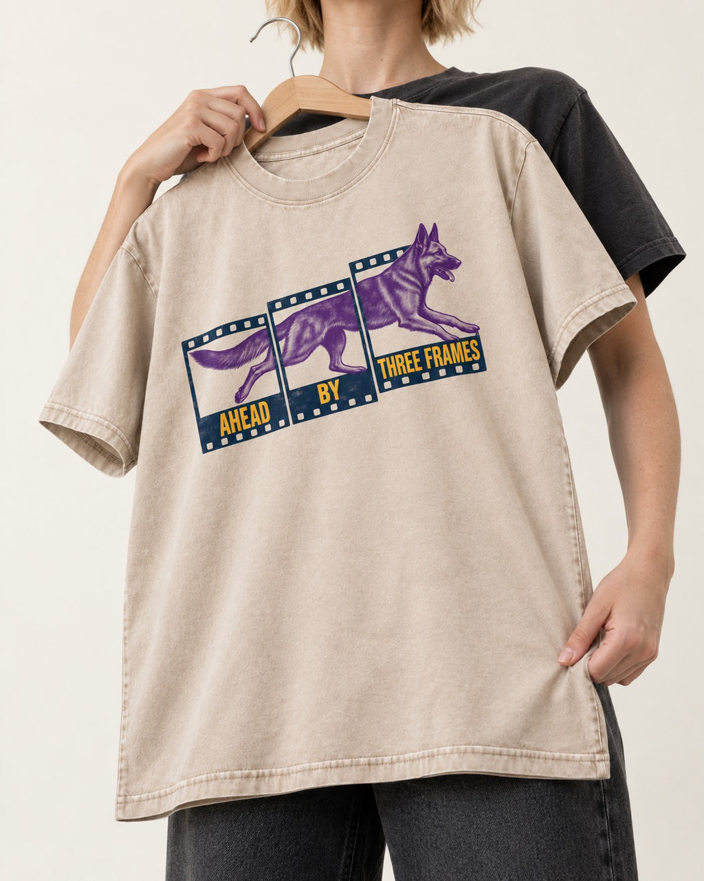 German Shepherd Dog Ahead by Three Frames Washed Tee in Apricot, held up on a hanger