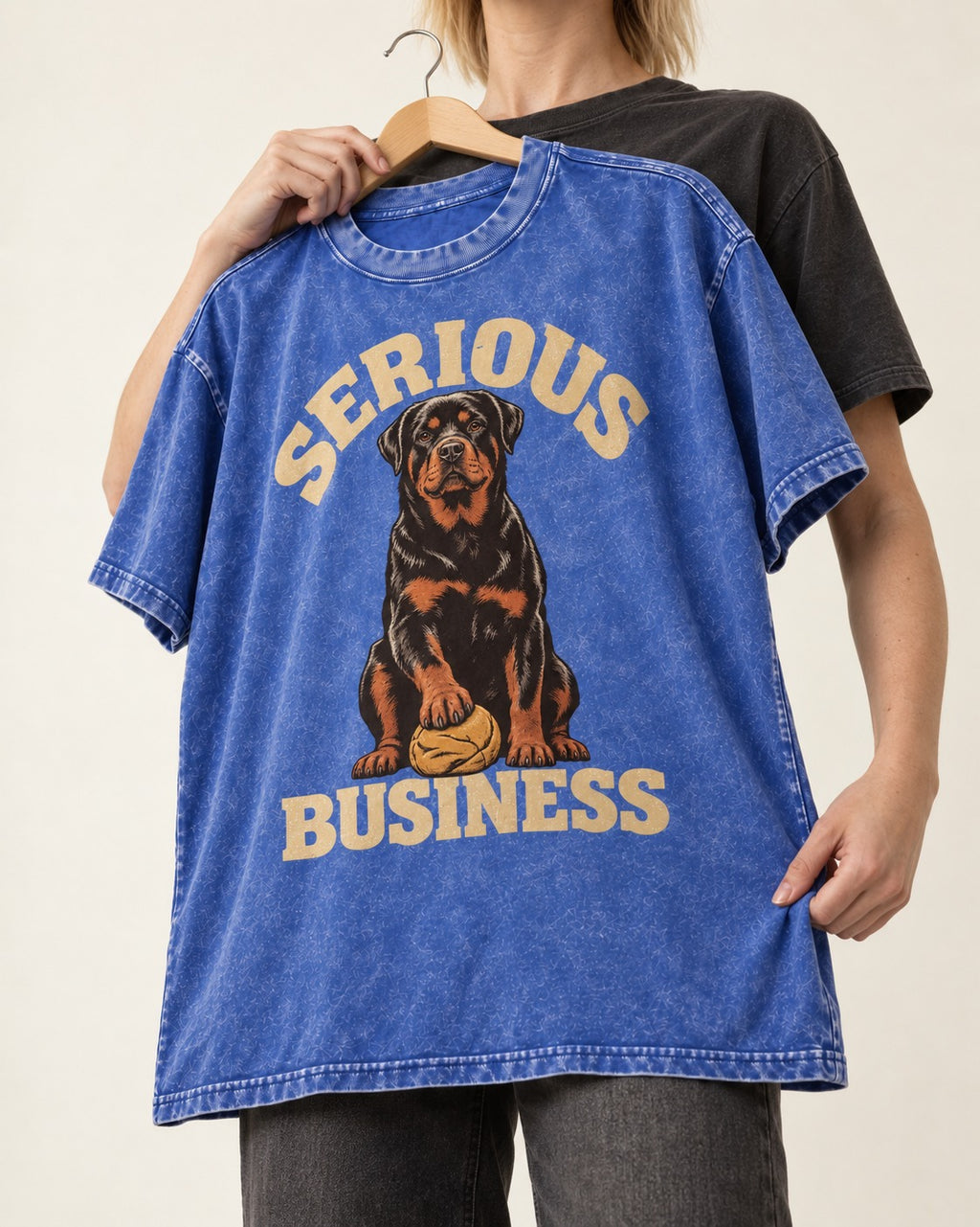 Rottweiler Serious Business Ball Under Paw Graphic Washed Tee in Royal Blue, held up on a hanger
