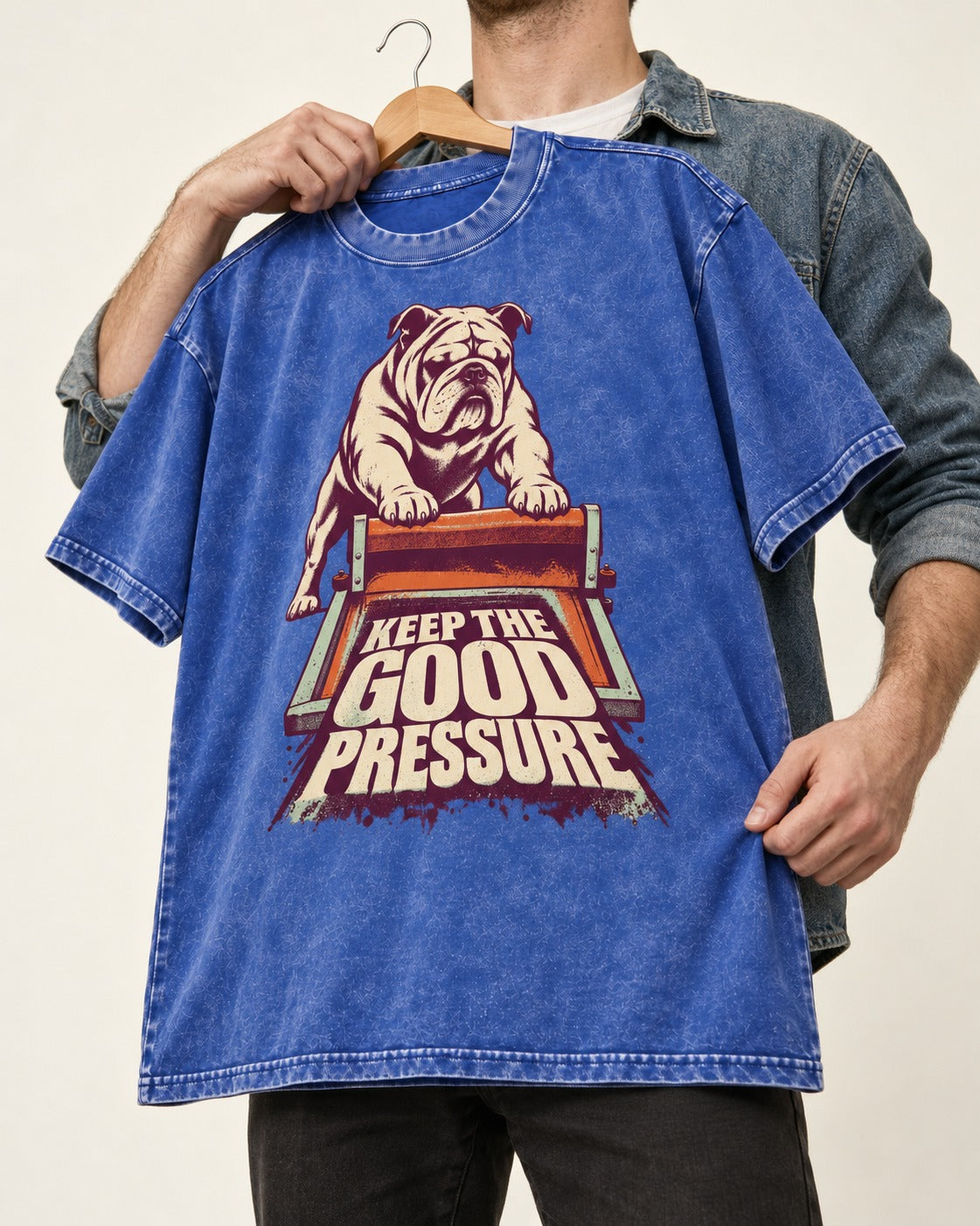 English Bulldog Keep the Good Pressure Printing Press Graphic Washed Tee in Royal Blue, held up on a hanger