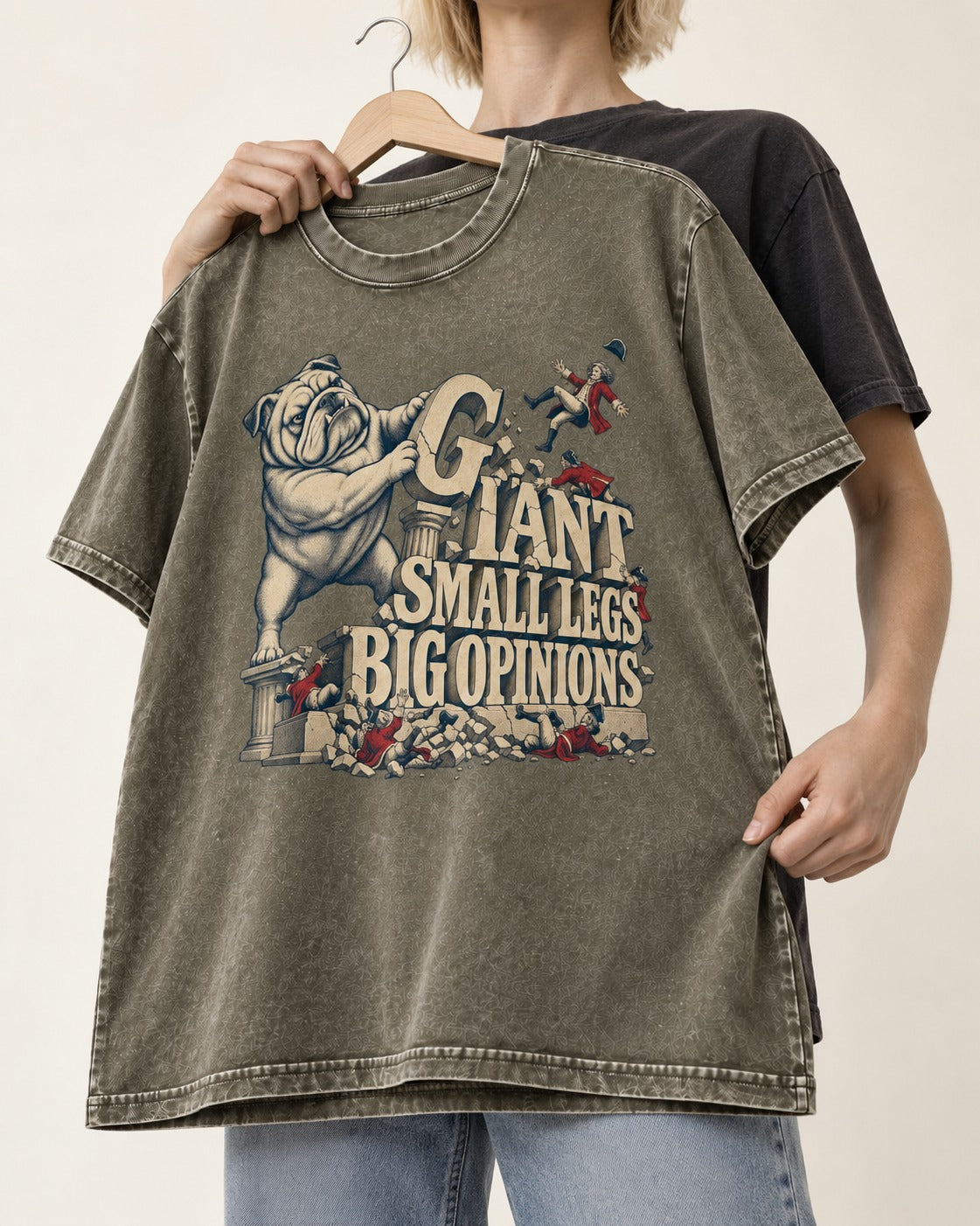 English Bulldog Giant Small Legs Big Opinions Monument Graphic Washed Tee in Army Green, held up on a hanger