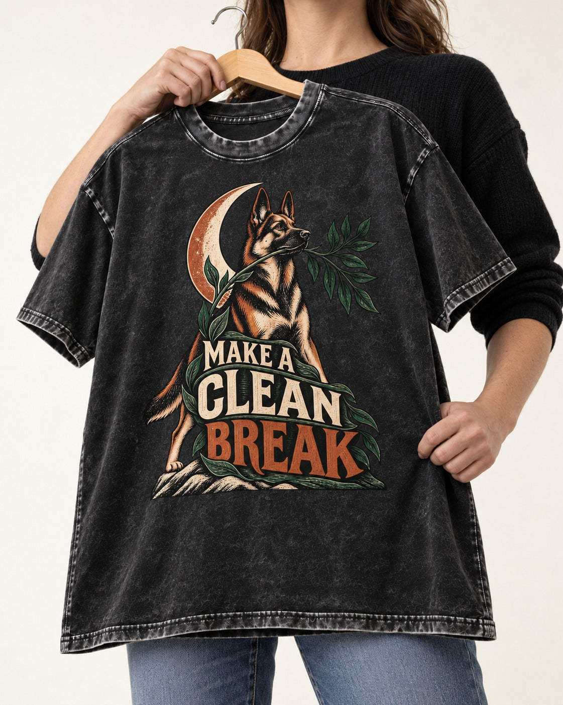 Make A Clean Break Crescent Botanical German Shepherd Dog Graphic Washed Tee in Black, held up on a hanger