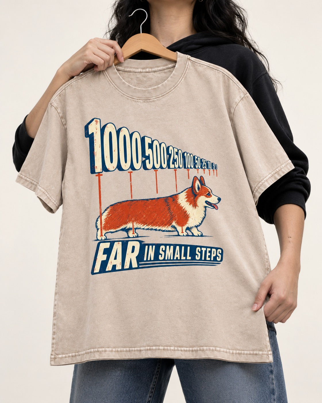 Corgi Far in Small Steps Washed Tee in Apricot, held up on a hanger