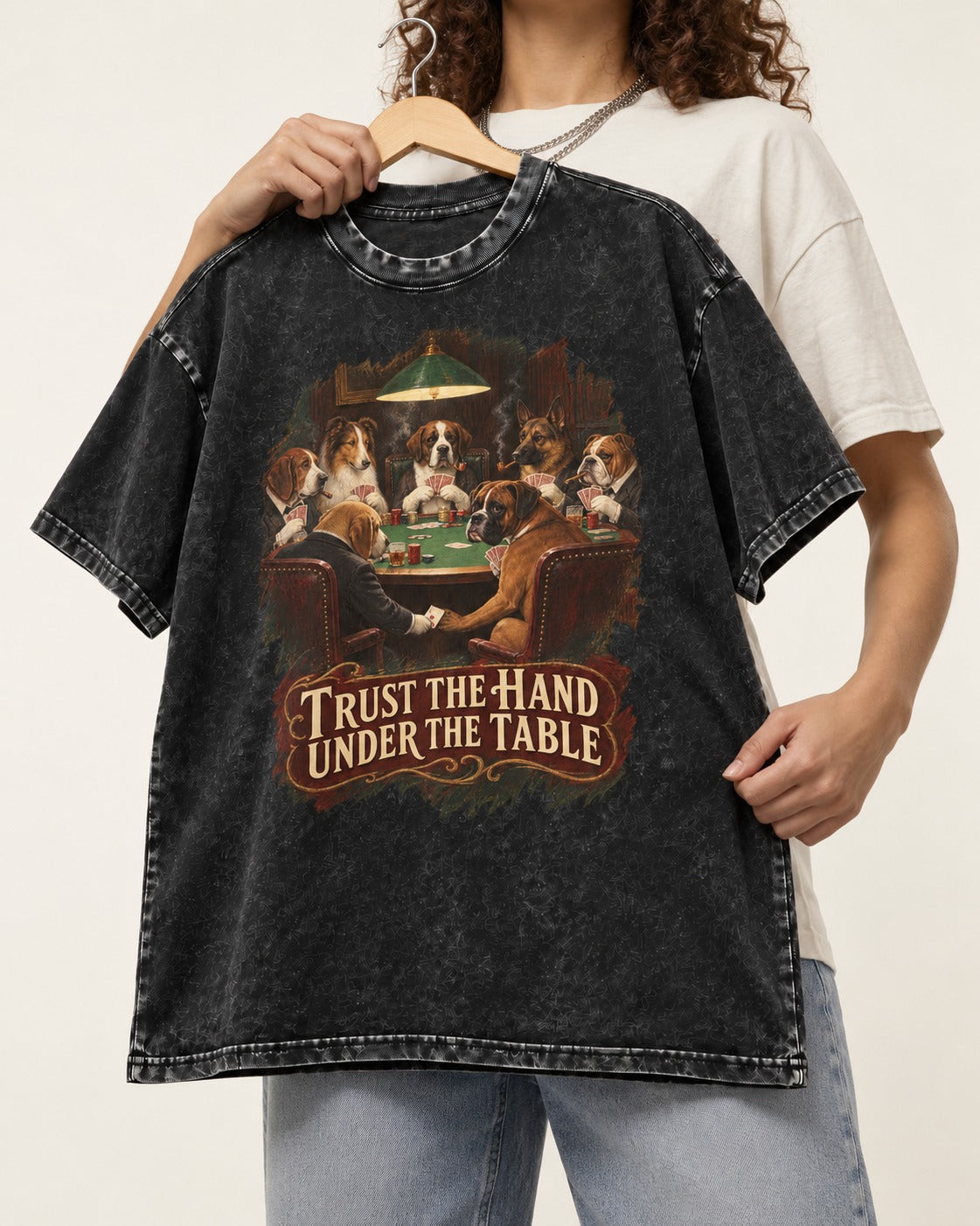 Trust the Hand Under the Table Boxer Poker Graphic Washed Tee in Black, held up on a hanger