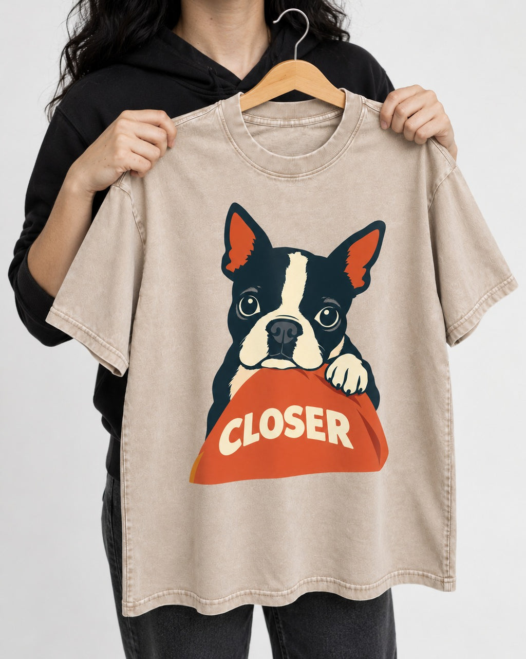 Come Closer Boston Terrier Washed Tee in Apricot, held up on a hanger