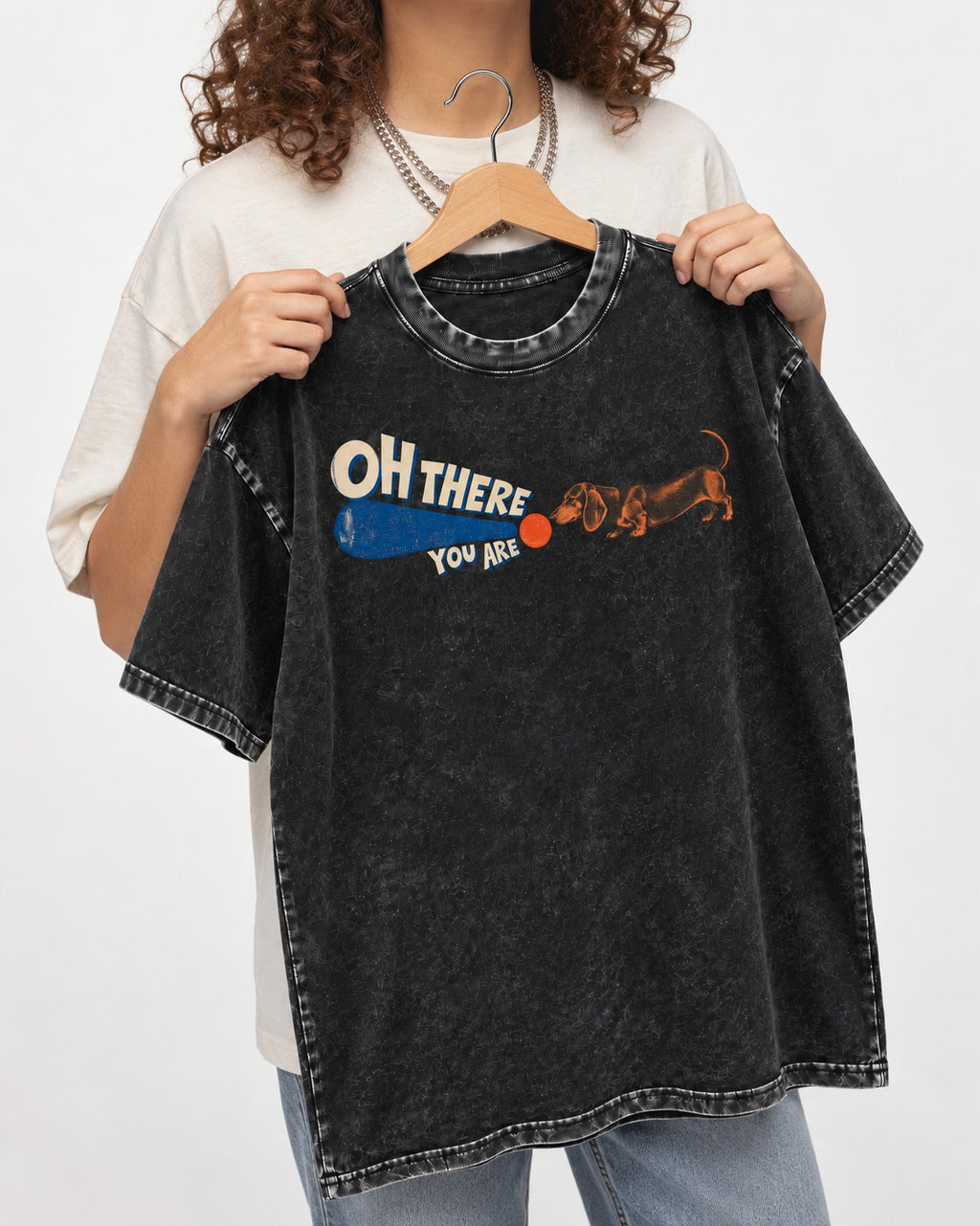 Dachshund Oh There You Are Ball Graphic Washed Tee in Black, held up on a hanger