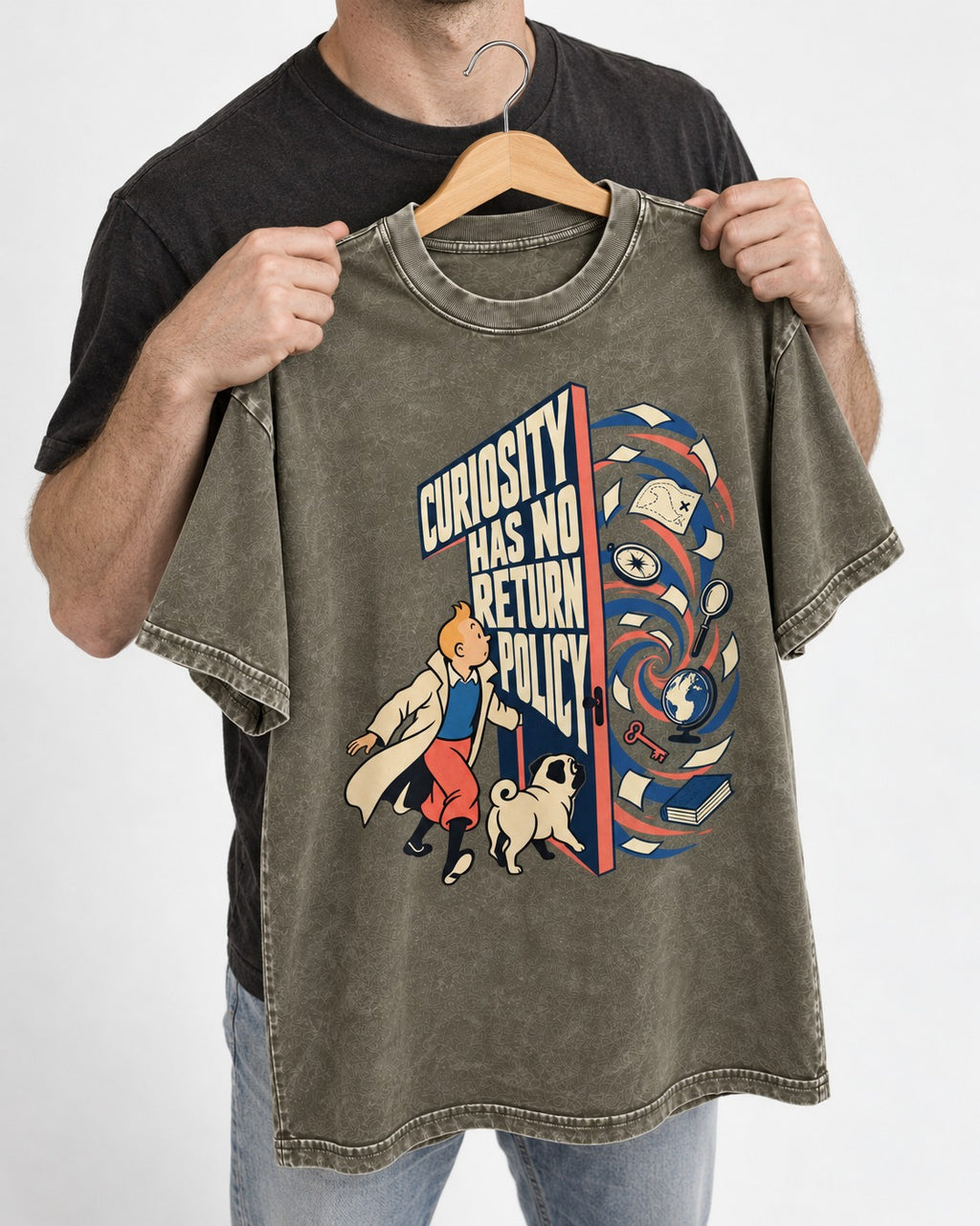 Pug Curiosity Has No Return Policy Portal Graphic Washed Tee in Army Green, held up on a hanger