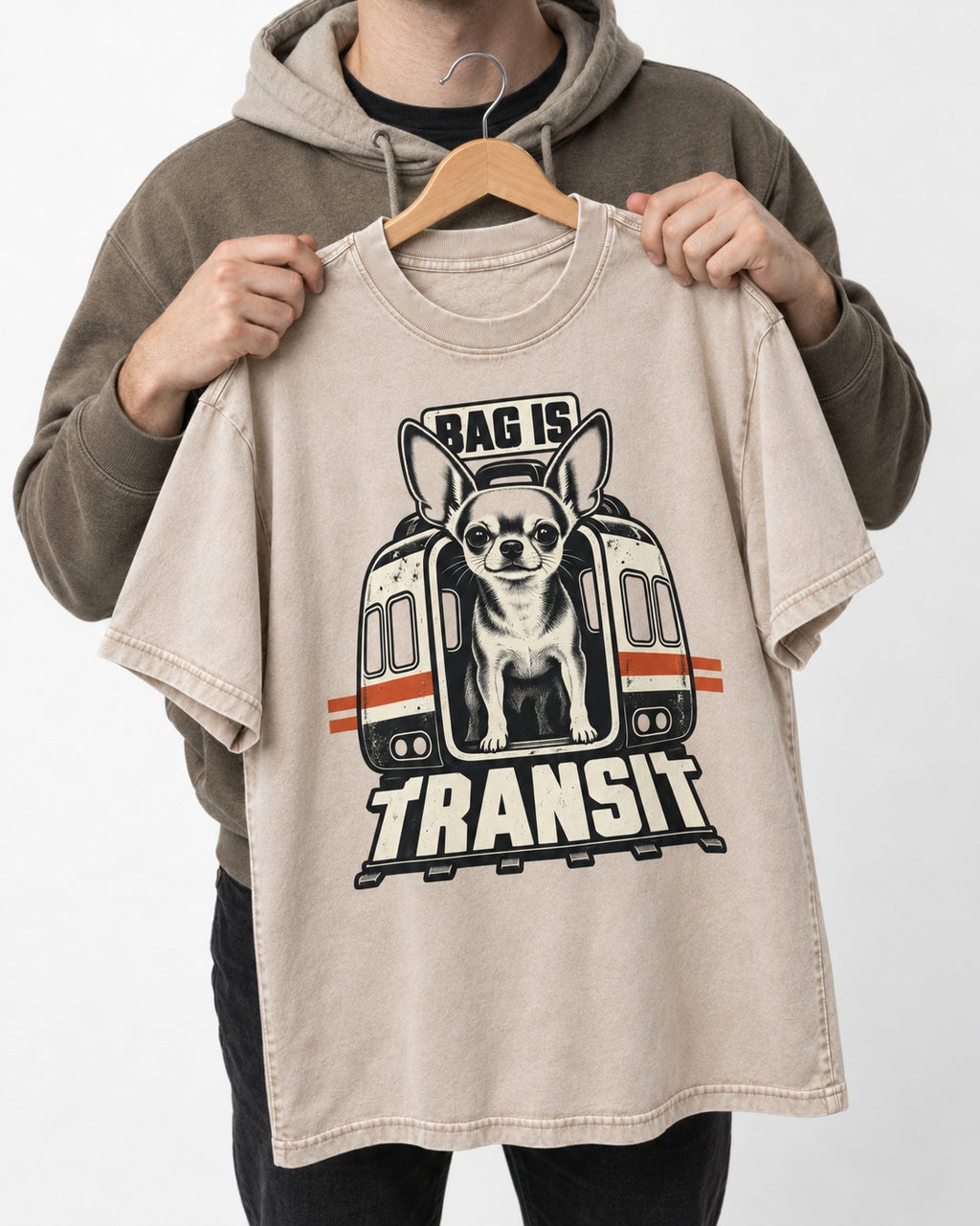 Chihuahua Bag Is Transit Train Front Graphic Washed Tee in Apricot, held up on a hanger