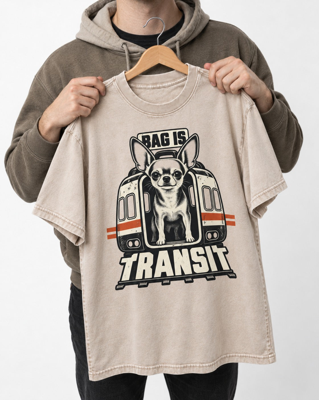 Chihuahua Bag Is Transit Train Front Graphic Washed Tee in Apricot, held up on a hanger