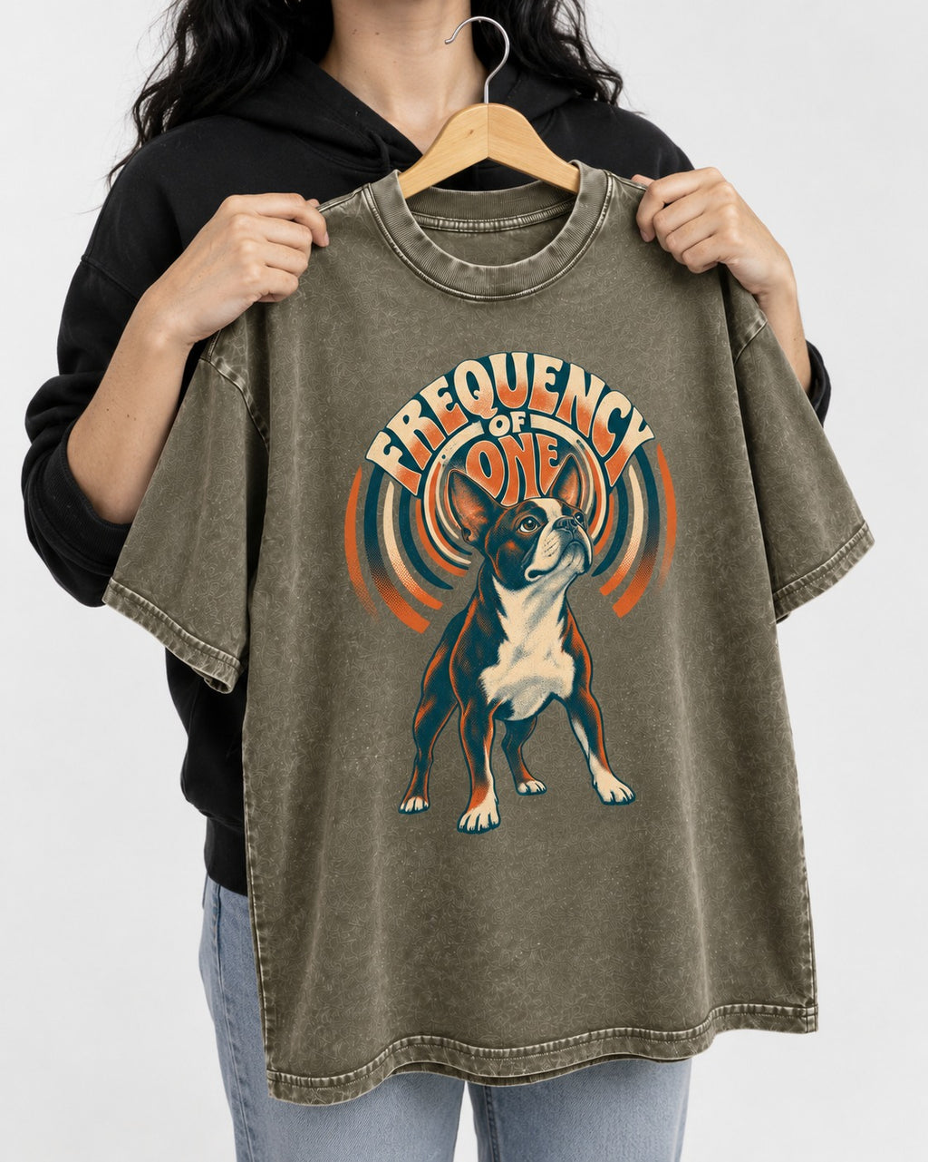 Frequency of One Boston Terrier Graphic Washed Tee in Army Green, held up on a hanger