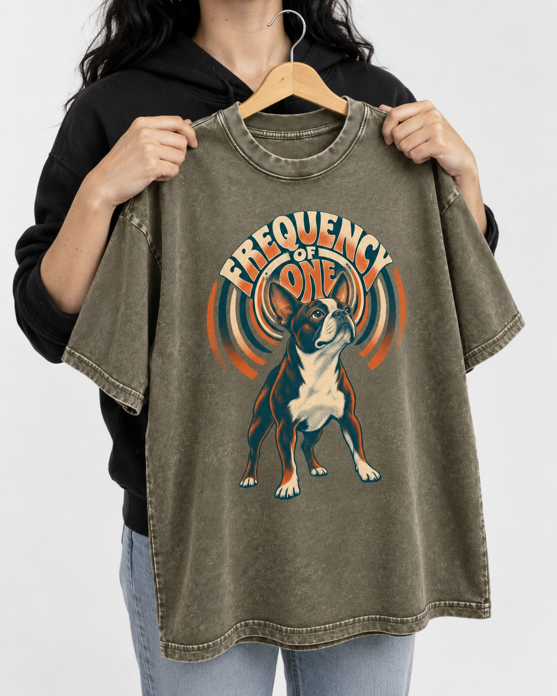 Frequency of One Boston Terrier Graphic Washed Tee in Army Green, held up on a hanger