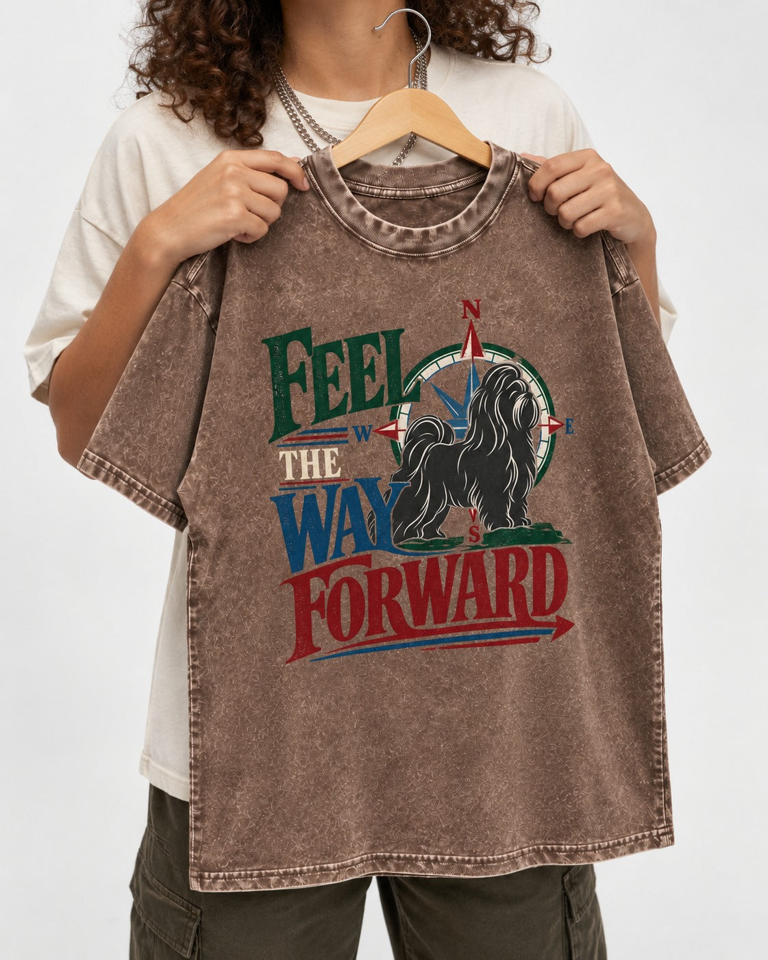 Shih Tzu Feel the Way Forward Compass Graphic Washed Tee in Coffee, held up on a hanger