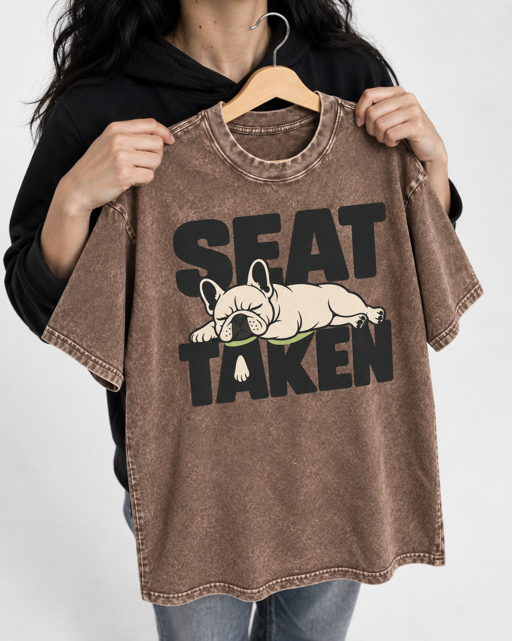 Seat Taken by Frenchie Washed Tee in Coffee, held up on a hanger