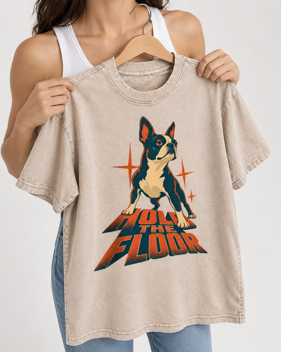 Boston Terrier On The Floor Perspective Graphic Washed Tee in Apricot, held up on a hanger
