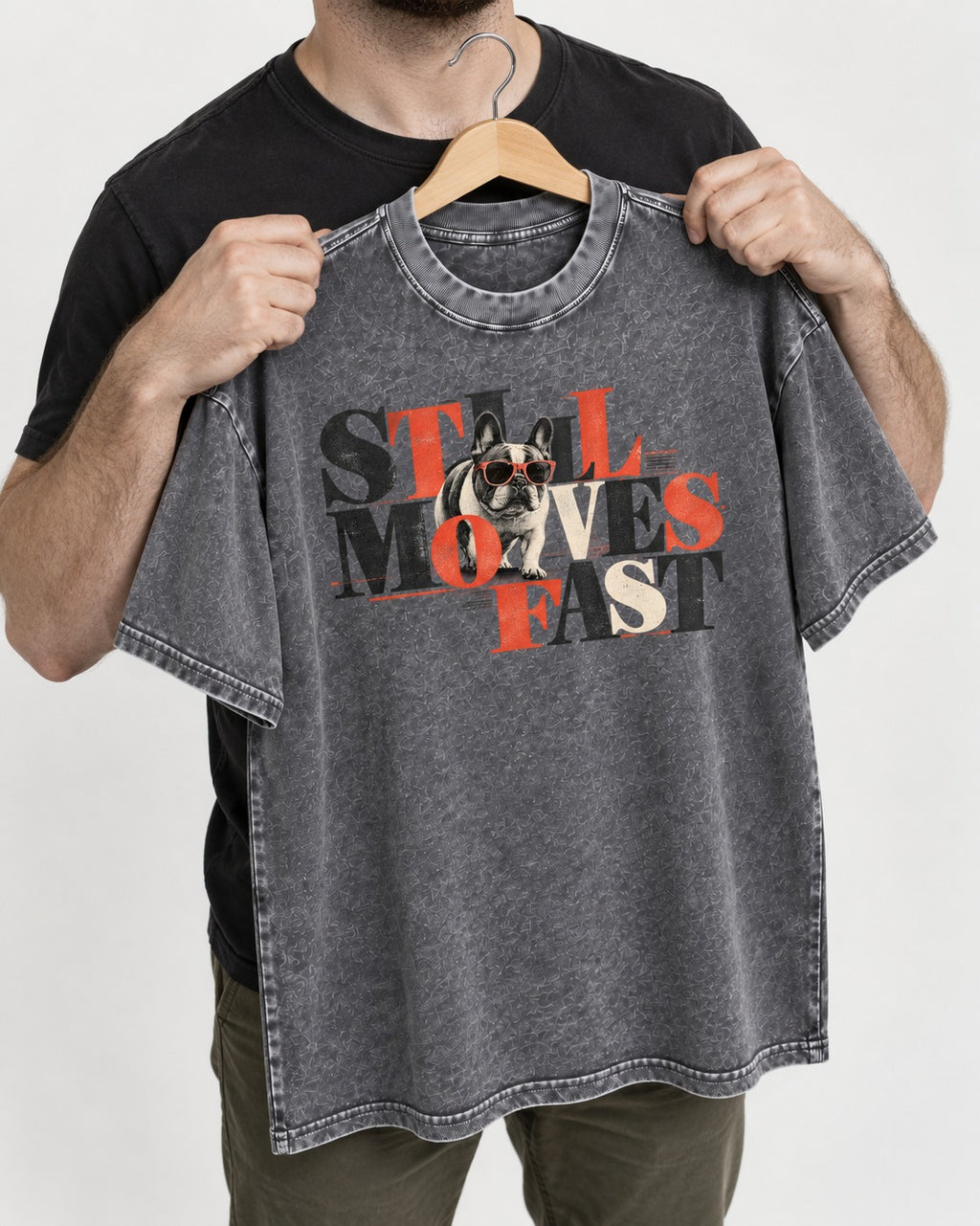 Frenchie Still Moves Fast Washed Tee in Gray, held up on a hanger