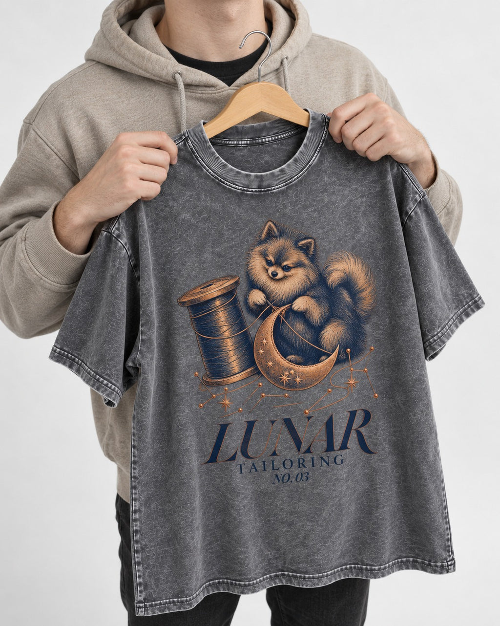 Pomeranian's Lunar Tailoring Washed Tee in Gray, held up on a hanger
