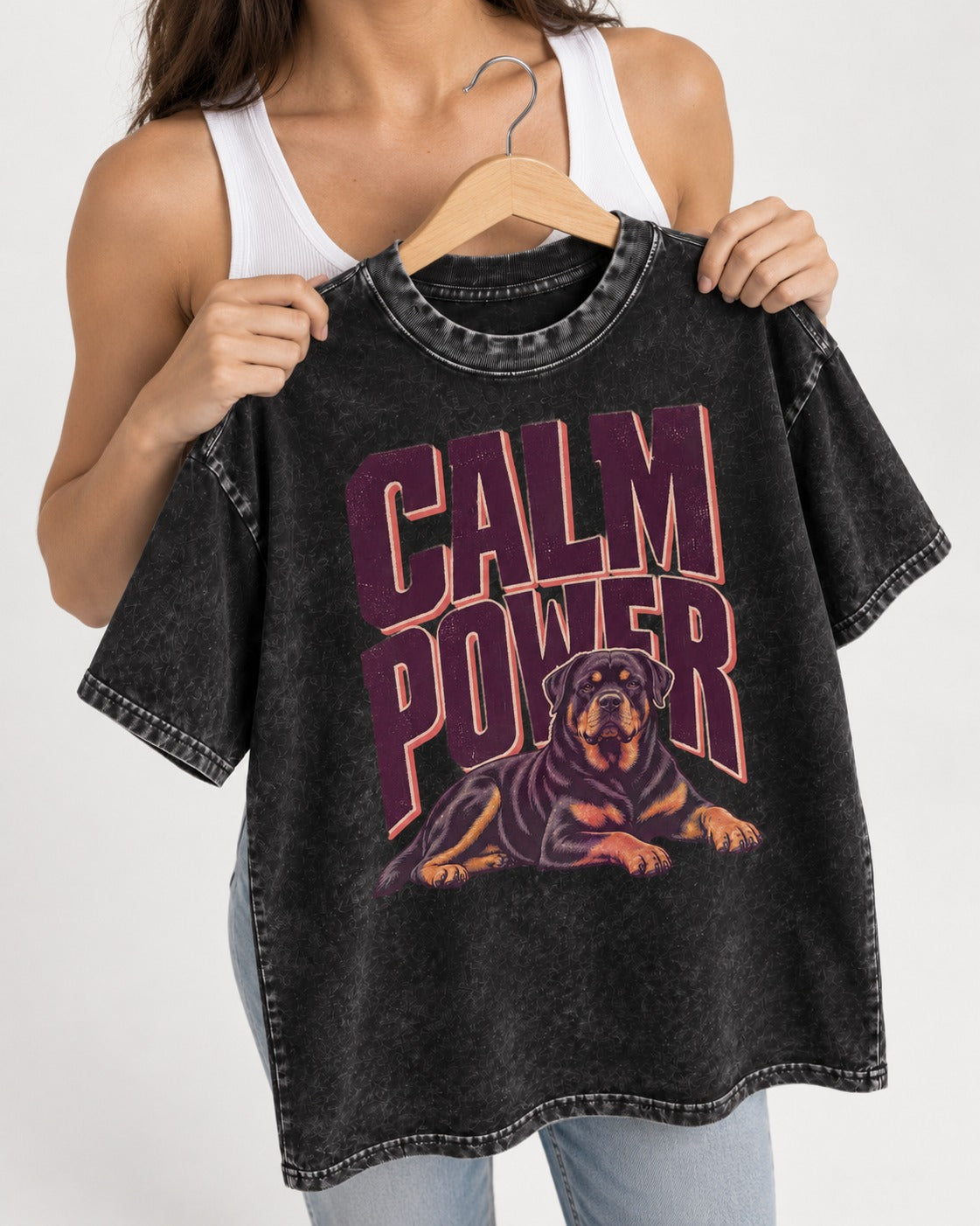 Rottweiler Calm Power Resting Dog Graphic Washed Tee in Black, held up on a hanger