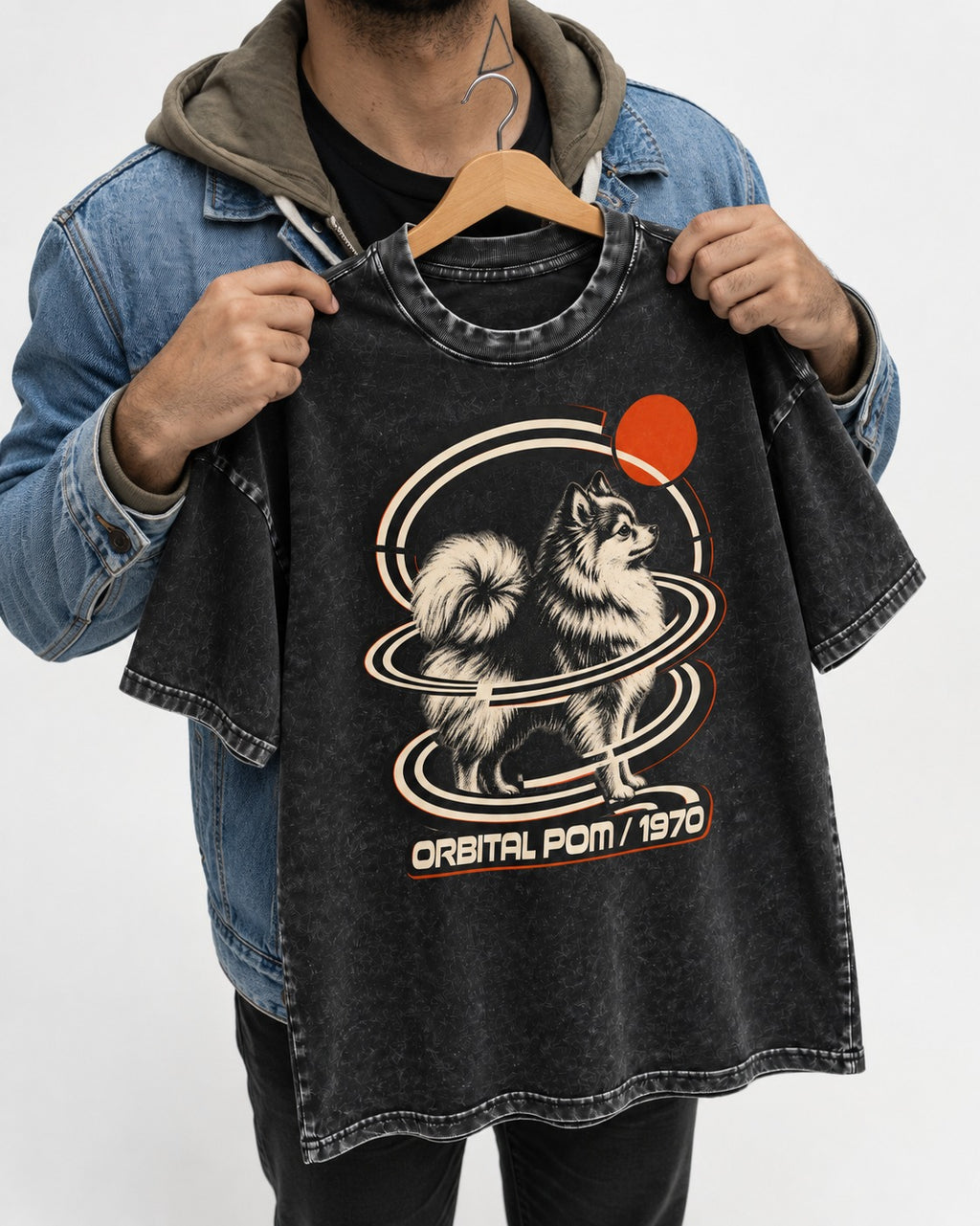 Pomeranian Orbital Pom 1970 Space Age Graphic Washed Tee in Black, held up on a hanger