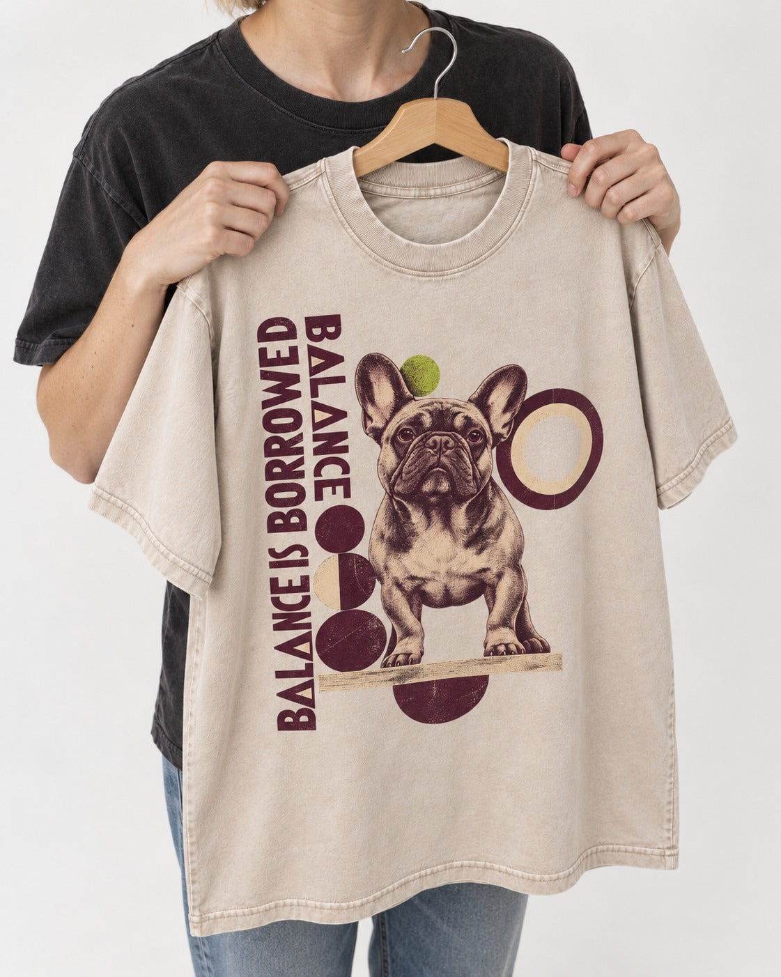 Frenchie's Balance Is Borrowed Washed Tee in Apricot, held up on a hanger