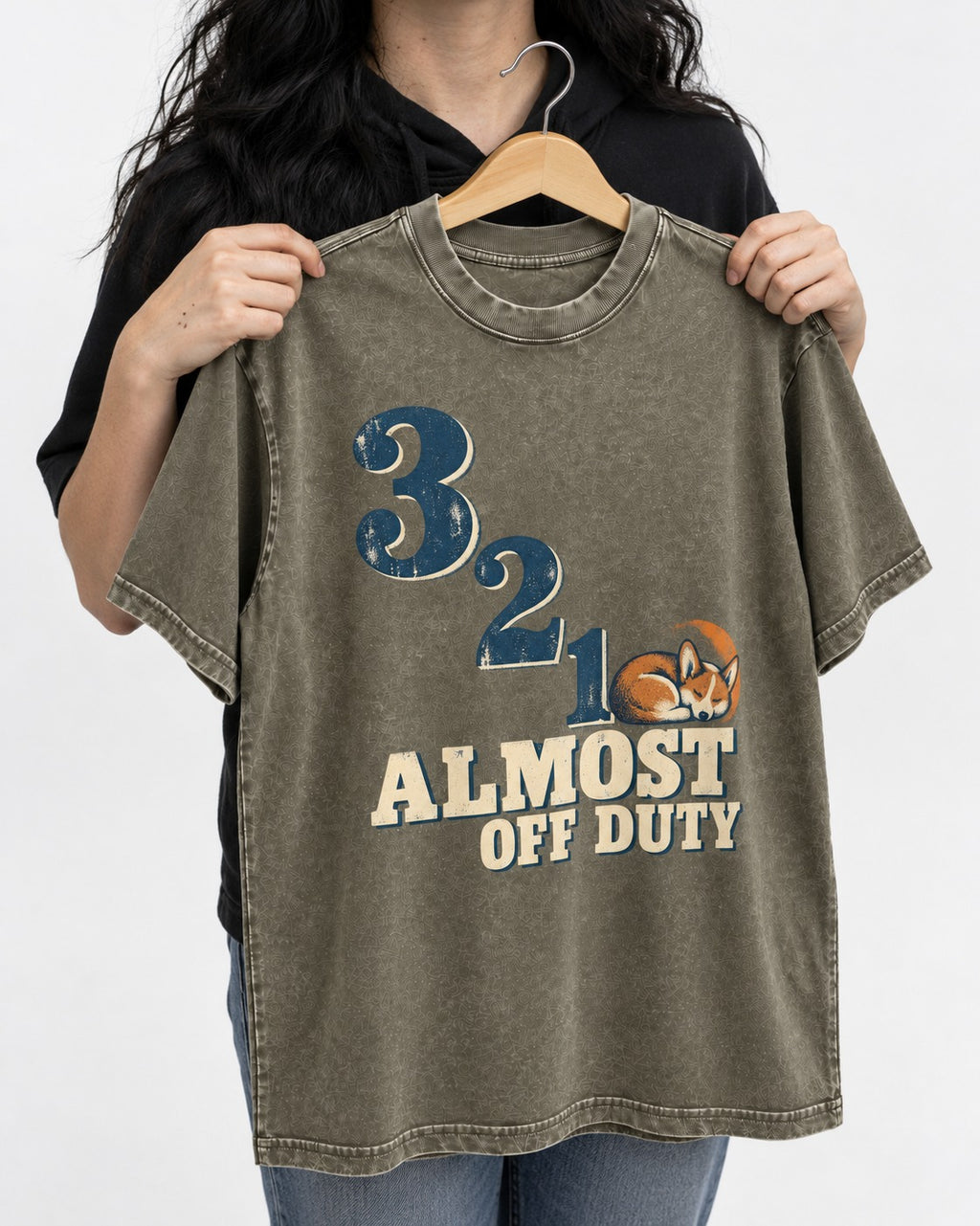 Corgi Almost Off Duty Washed Tee in Army Green, held up on a hanger