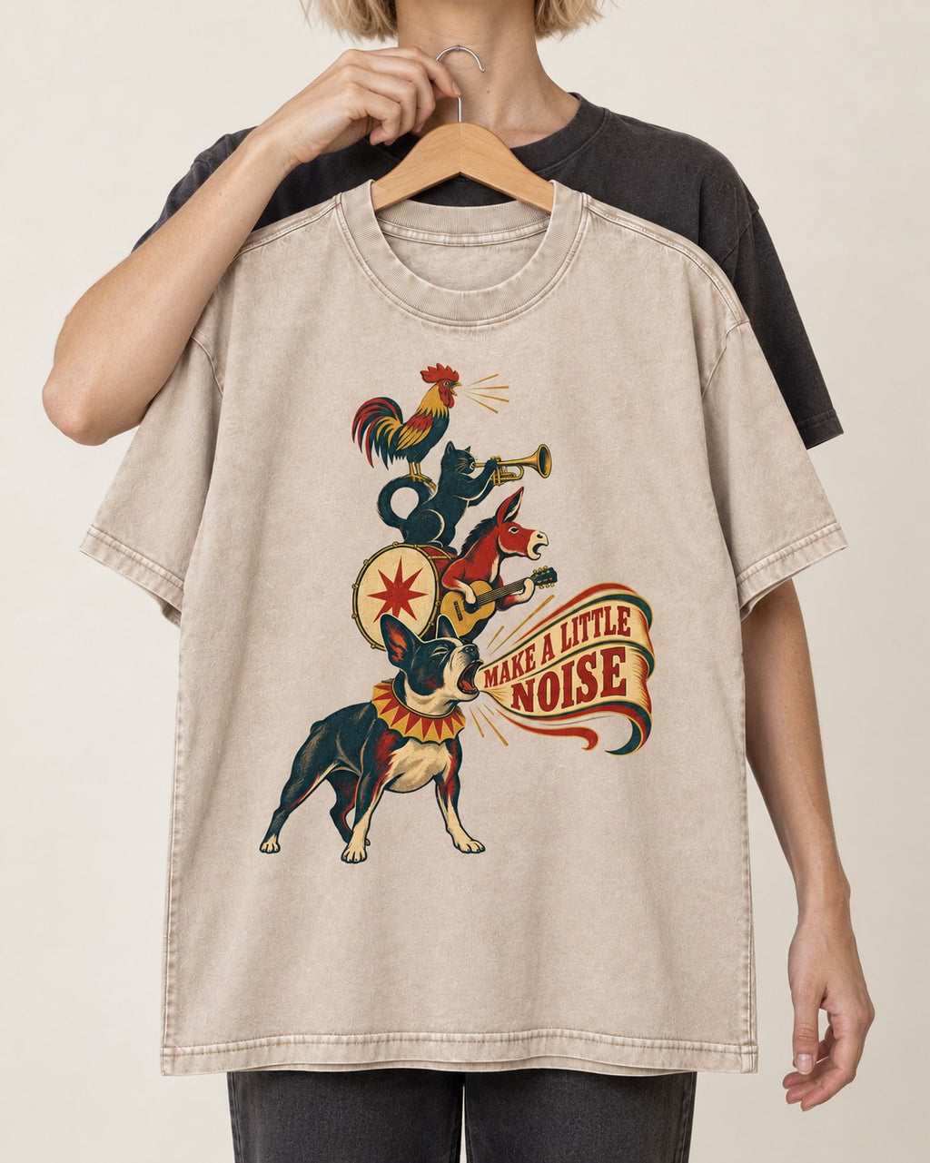Boston Terrier Make A Little Noise Washed Tee in Apricot, held up on a hanger