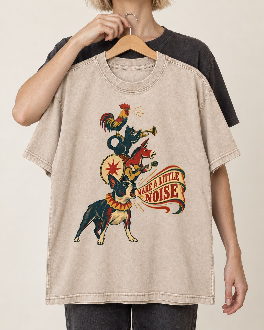 Boston Terrier Make A Little Noise Washed Tee in Apricot, held up on a hanger