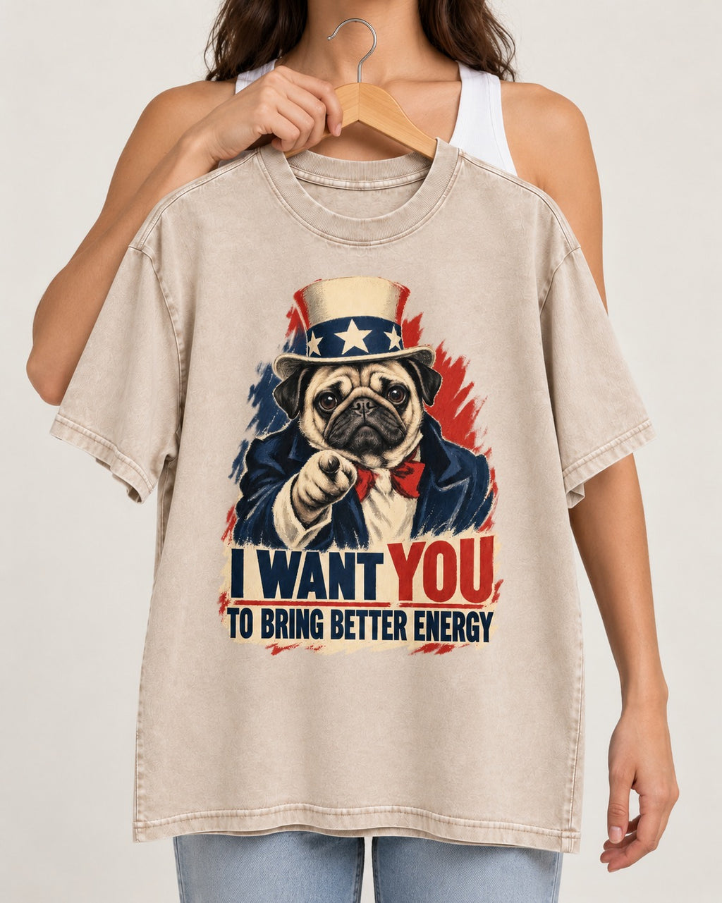 Pug I Want You to Bring Better Energy Uncle Sam Graphic Washed Tee in Apricot, held up on a hanger