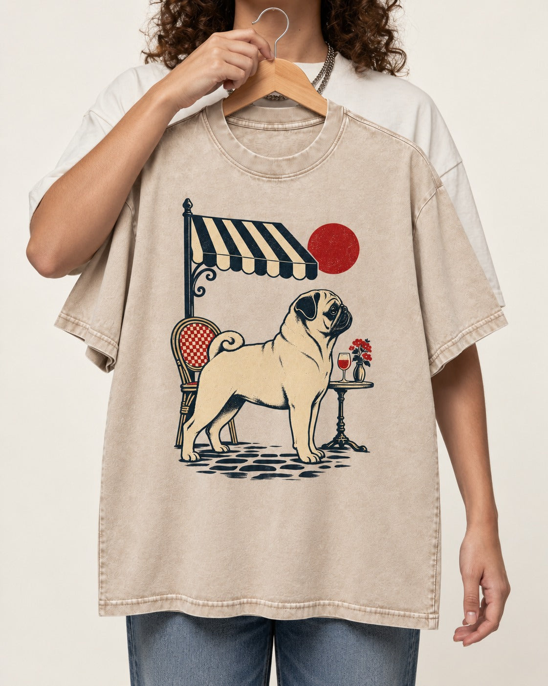 Pug Joie De Vivre Washed Tee in Apricot, held up on a hanger