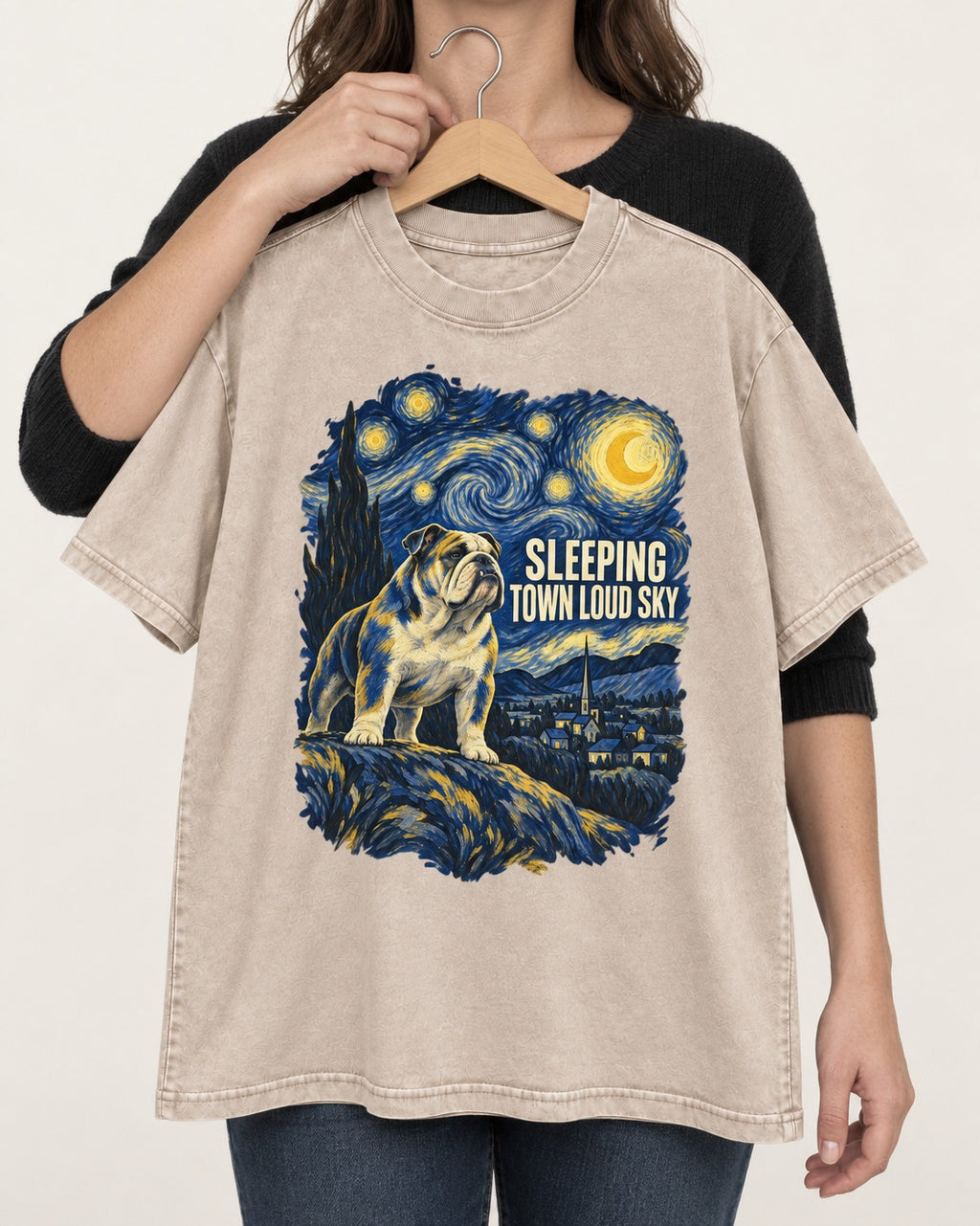 English Bulldog Sleeping Town Loud Sky Starry Night Graphic Washed Tee in Apricot, held up on a hanger