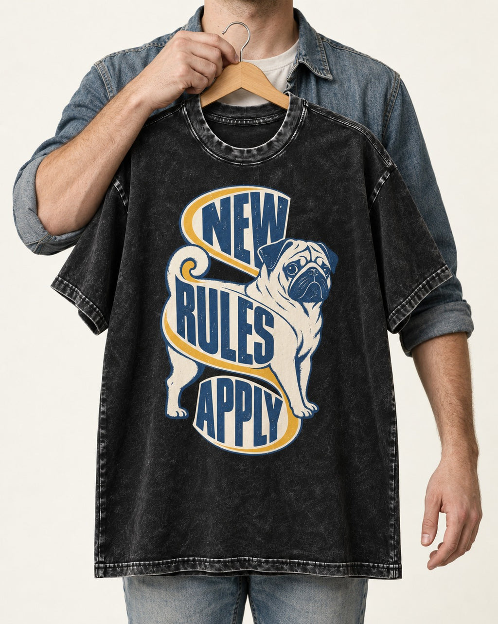 Pug New Rules Apply Ribbon Graphic Washed Tee in Black, held up on a hanger