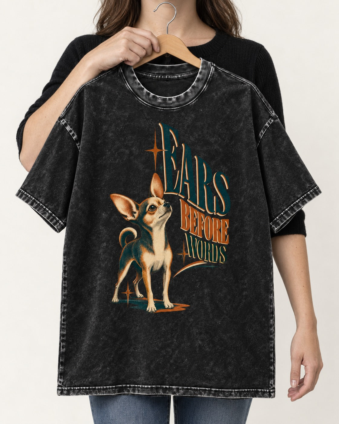 Chihuahua Ears Before Words Retro Typography Washed Tee in Black, held up on a hanger