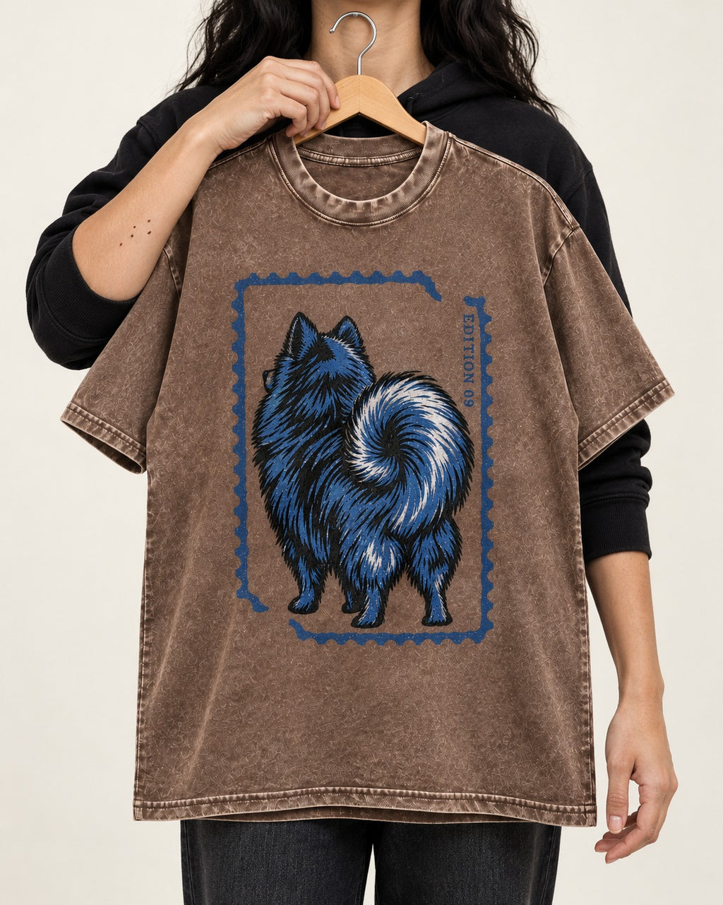 Pomeranian Pride Washed Tee in Coffee, held up on a hanger