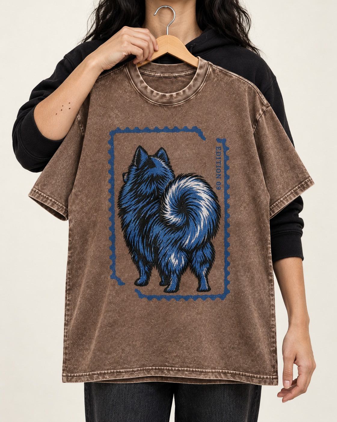 Pomeranian Pride Washed Tee in Coffee, held up on a hanger