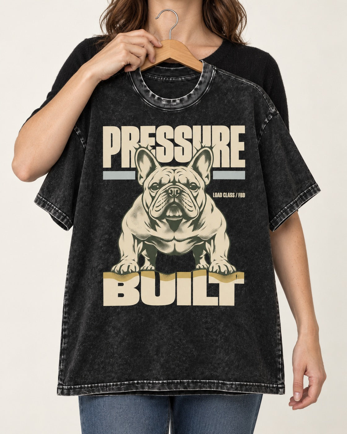 Frenchie Pressure Built Load Class Graphic Washed Tee in Black, held up on a hanger