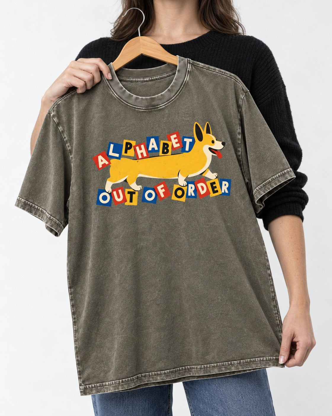 Corgi Alphabet Out of Order Graphic Washed Tee in Army Green, held up on a hanger