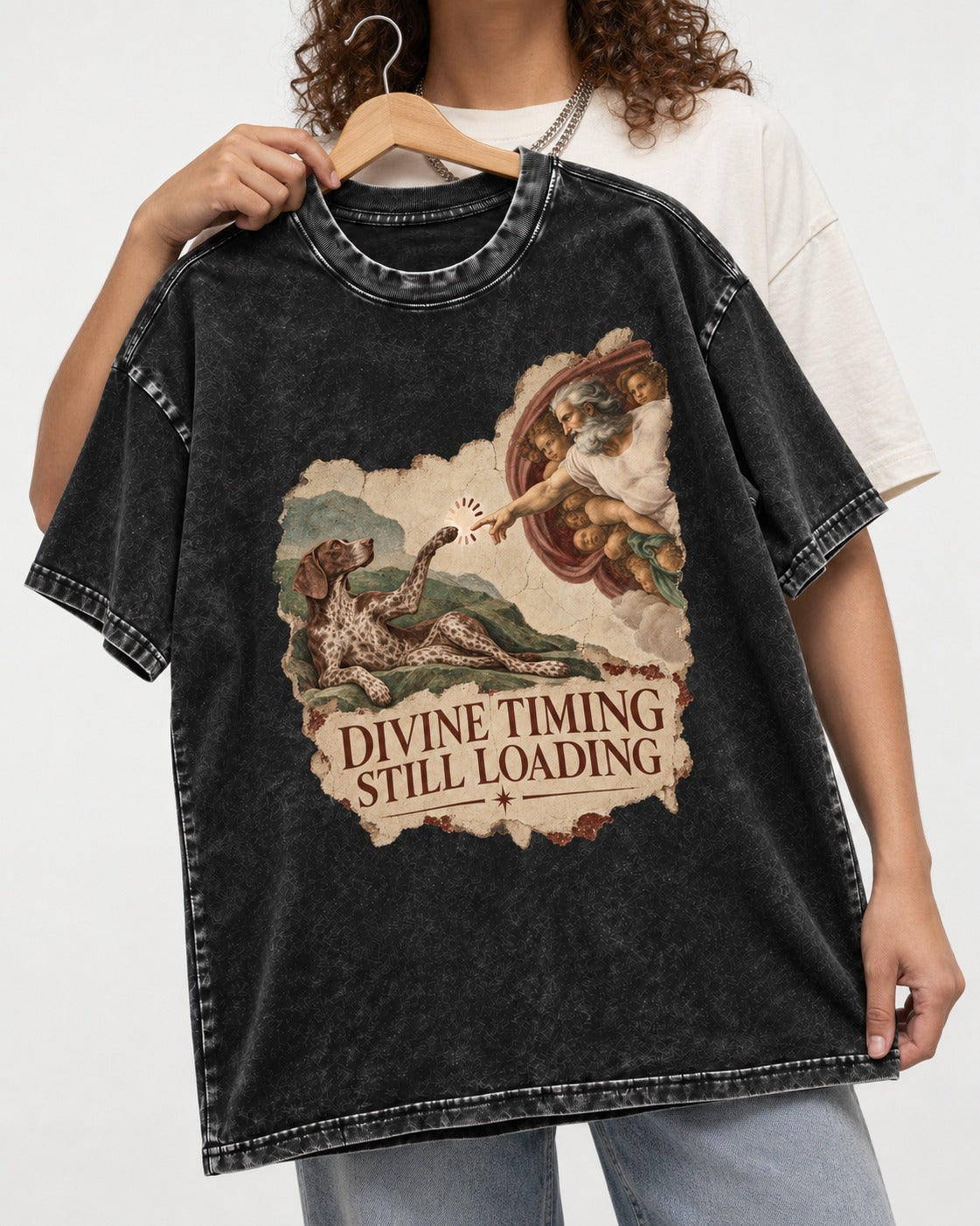 German Shorthaired Pointer Divine Timing Still Loading Creation Scene Graphic Washed Tee in Black, held up on a hanger