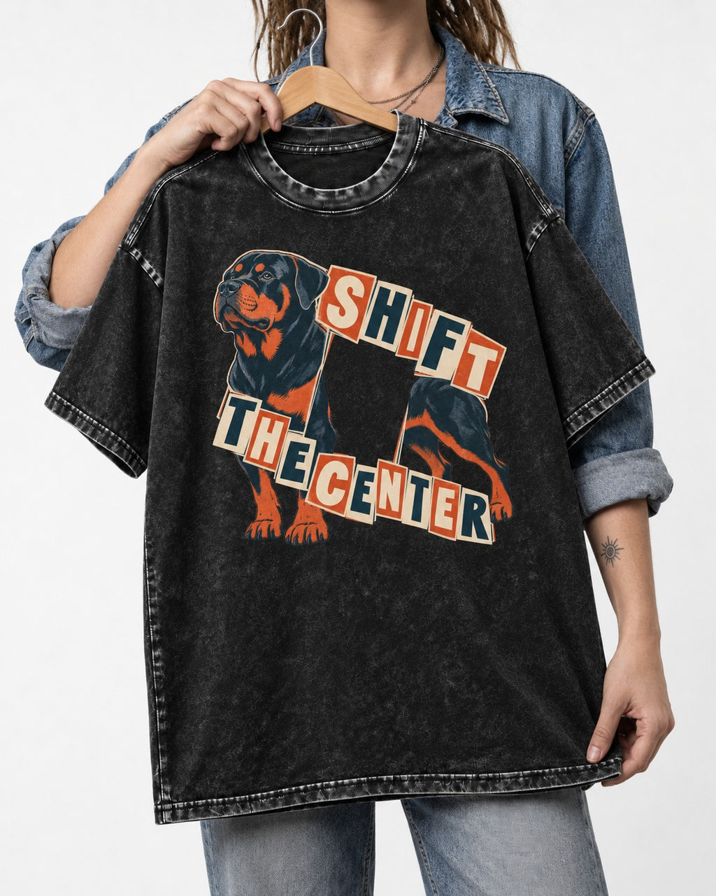 Rottweiler Shift the Center Cutout Letter Graphic Washed Tee in Black, held up on a hanger